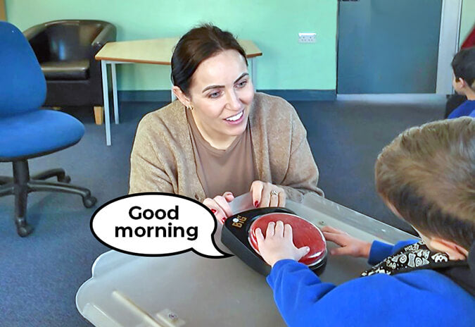 BIGmack AAC device used by teacher for morning registration