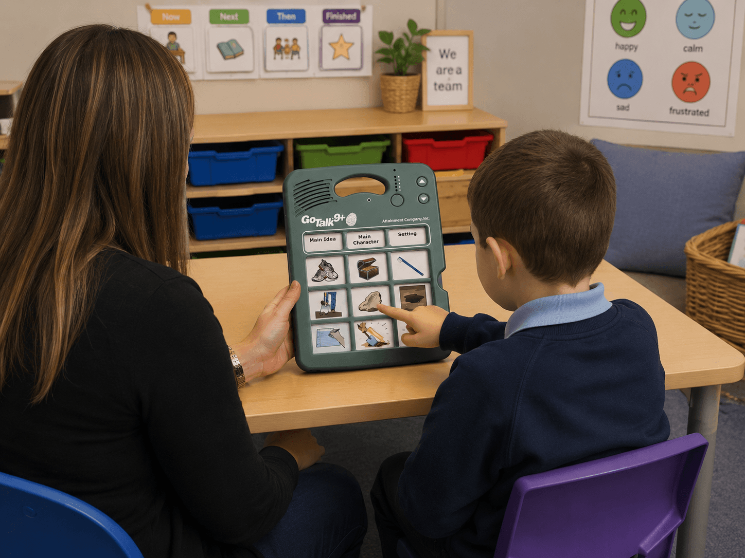 Teacher and student using a GoTalk 9+ Lite communication device in a classroom